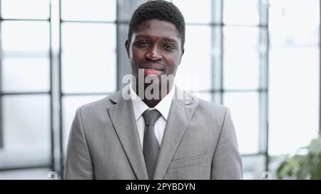Smiling millennial confident black guy posing for photo, looking at camera Stock Photo