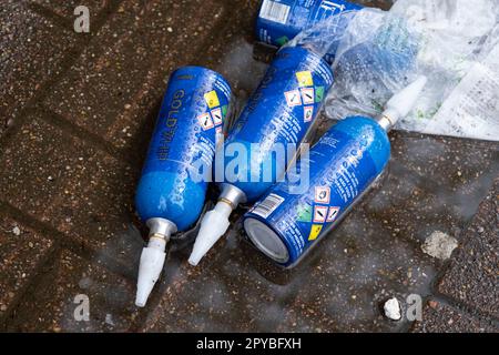 Empty large size cannisters of Goldwhip nitrous oxide / laughing gas lying on the street on 23rd April 2023 in London, United Kingdom. It has been reported that these large cannisters, which are currently legal, are being used by young people in particular, but the amount of gas which they are taking due to difficulty in guaging the amount taken, is creating long term negative health affects. Nitrous oxide, commonly known as laughing gas, nitrous, nitro, or NOS is now a very common legal high used by young people. Nitrous oxide can cause analgesia, depersonalisation, derealisation, dizziness, Stock Photo