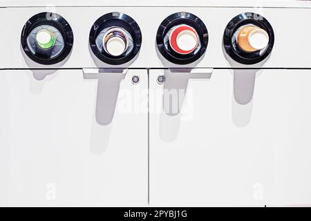 paper cups in a vending machine with various drinks Stock Photo