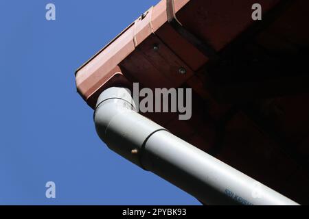 PVC pipe connected to the roof to carry rainwater from the top to ground Stock Photo