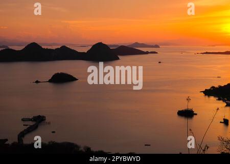 Silhouette view at sunset on a hilltop in Labuan Bajo, Indonesia Stock Photo