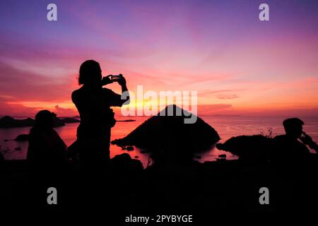 Silhouette view at sunset on a hilltop in Labuan Bajo, Indonesia Stock Photo
