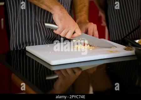 Traditional way of preparing indian food using chopper knife. Picture of traditional India cuisine made of fresh ingredients taken during cooking clas Stock Photo