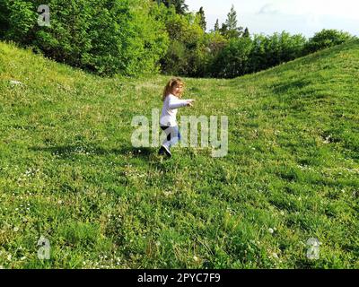 Girl dressed in blue and white striped dress holding a vinyl record o ...