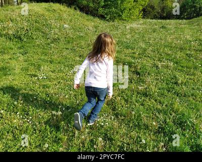 Girl dressed in blue and white striped dress holding a vinyl record o ...