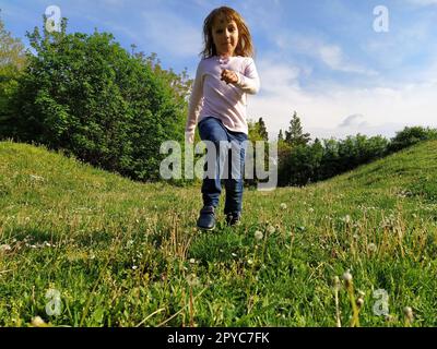 Girl dressed in blue and white striped dress holding a vinyl record o ...