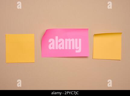 Multi-colored paper stickers for notes on a beige background, a place for writing data, notes Stock Photo