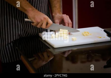 Traditional way of preparing indian food using chopper knife. Picture of traditional India cuisine made of fresh ingredients taken during cooking clas Stock Photo
