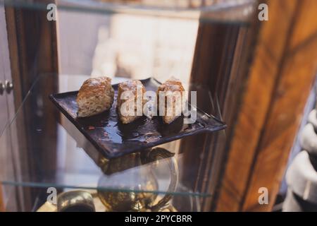 Cakes with honey and nuts served in the cafe or bakery window. Homemade sweet bakery product Stock Photo