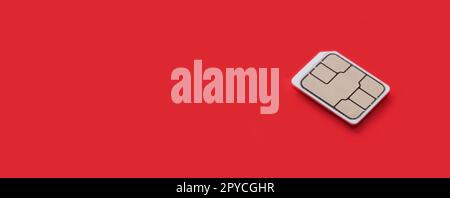 SIM Card - Isolated on red background. banner size, panorama, with copyspace for your individual text. Stock Photo
