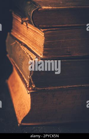 Vintage books stack on old wooden surface Stock Photo