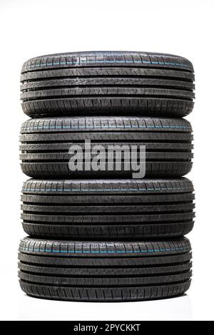 Stack of brand new high performance car tires on clean high-key white studio background Stock Photo