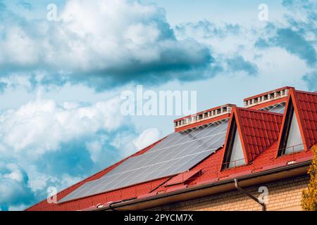Solar panels on a house with a red roof Stock Photo