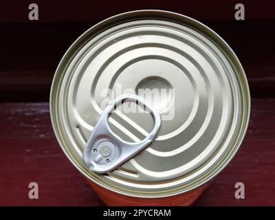 canned food lid with a bottle opener. Hook metal can top for easy opening Stock Photo