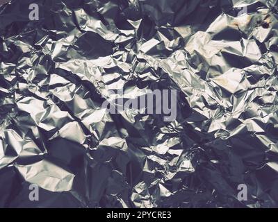 foil close-up. Aluminum silver crumpled foil. Abstract metallic background. Foil for baking food. Background Stock Photo
