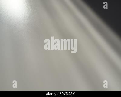 Diagonal rays of light on a gray background. Blurred abstract background light effect and leaks. Side surface illumination. Parallel, divergent and asymmetric lines, stripes of light at an angle Stock Photo