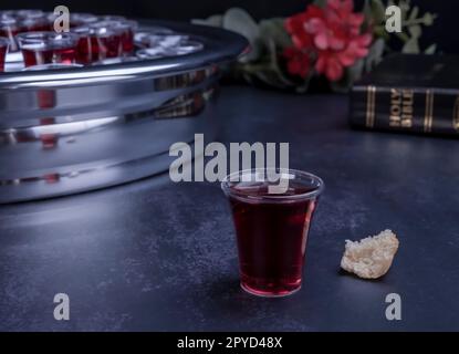 Taking communion concept - the wine and the bread symbols of Jesus Christ blood and body with Holy Bible Stock Photo