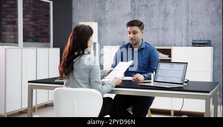 Two Businesspeople Talking With Each Other Stock Photo