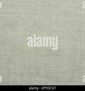 Fabric texture background. Light gray fabric with weave. Natural slightly wrinkled look of the material. Uniform copy space background. Cotton, canvas or woolen thin fabric laid evenly on the surface. Stock Photo