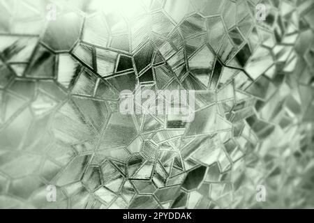 Corrugated glass green background. Abstract pattern on the surface of a window. Protective opaque film. Stock Photo