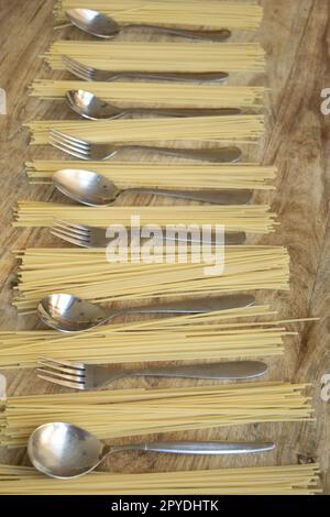 spaghetti and silver cutlery alternated Stock Photo