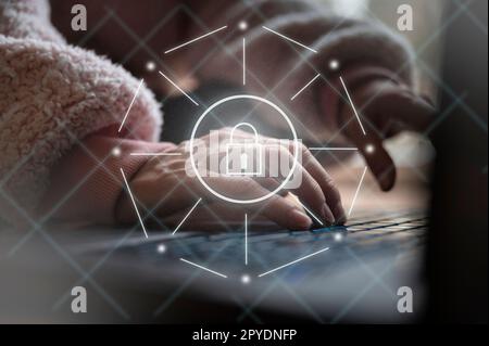 Cyber securtiy conceptual image - closeup view of female hands using laptop computer with a white glowing lock in front on virtual interface. Stock Photo