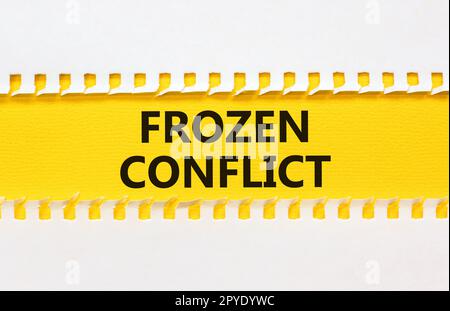 Frozen conflict symbol. Concept words Frozen conflict on beautiful yellow paper. Beautiful white table white background. Business and Frozen conflict Stock Photo