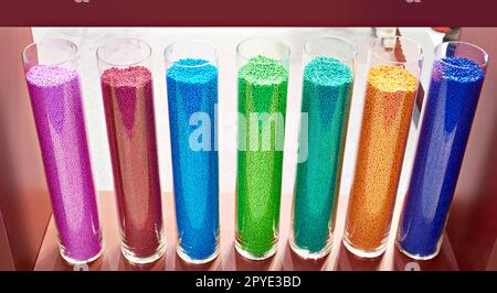 Color plastic granules in glass Stock Photo