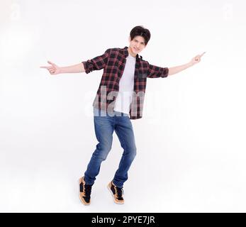 Excited young man dancing and jumping  isolated on white Stock Photo