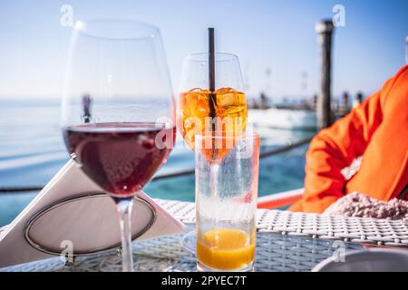 Cheers to good times: Elegant glassware on a seafront bar table Stock Photo