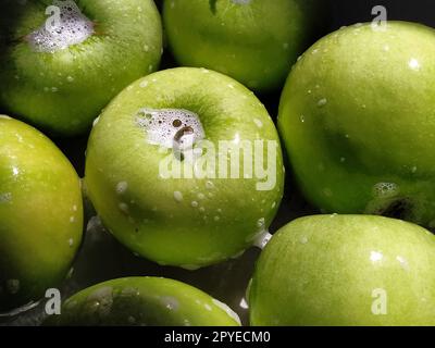 Washing fruit. Soapy green apples. Washing fruits and vegetables for the prevention of coronavirus covid-19 Stock Photo