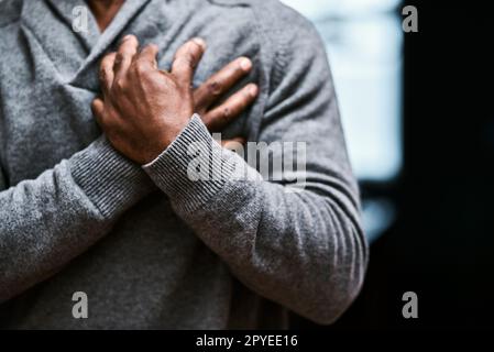 This could be a heart attack. an unrecognizable senior man holding his chest in pain. Stock Photo