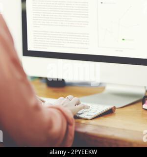 Getting through another busy day. Closeup shot of an unrecognizable businesswoman working on a computer in an office. Stock Photo