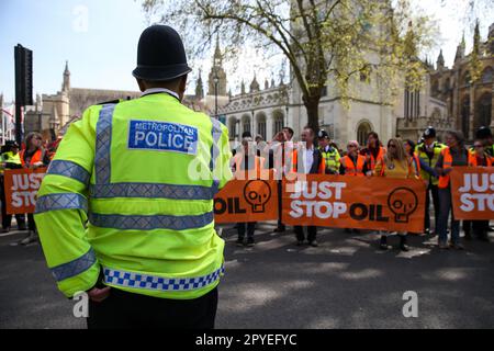 London, UK. 03rd May, 2023. A police officer speaks with protesters from Just Stop Oil as they slow march in Westminster, stopping the traffic outside Houses of Parliament. The group are demanding that UK government stops issuing new fossil fuel licences. (Photo by Steve Taylor/SOPA Images/Sipa USA) Credit: Sipa USA/Alamy Live News Stock Photo