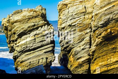 Beautiful rocks cliffs surfer waves at beach Puerto Escondido Mexico. Stock Photo