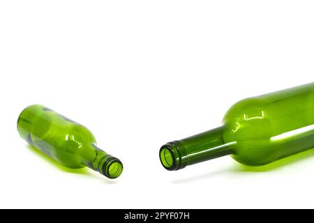 Small empty bottle of wine alongside a full size empty bottle of wine isolated on a plain white background. Copy space. Alcohol consumption concept. Stock Photo