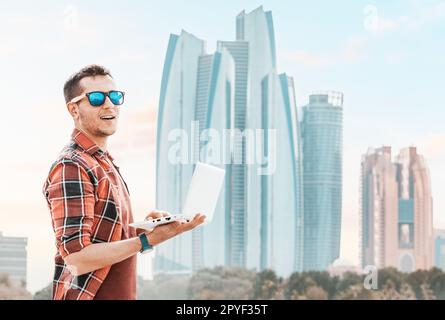 young man works diligently on his laptop, demonstrating the adaptability and flexibility that characterize remote work and education in the UAE, Abu D Stock Photo