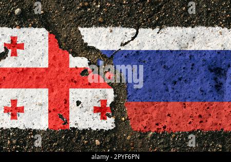 On the pavement are images of the flags of Georgia and Russia, as a symbol of confrontation. Conceptual image. Stock Photo