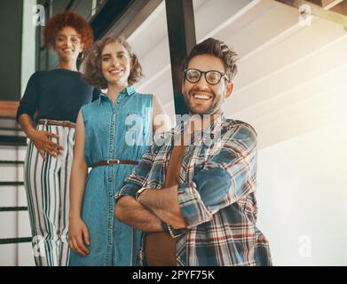 When it comes to business just take the first step. creative employees on the staircase at work. Stock Photo