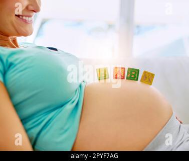 Baby coming soon. a pregnant woman standing in her home Stock Photo - Alamy