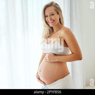 Doesnt she look good pregnant. a beautiful woman touching her pregnant belly. Stock Photo