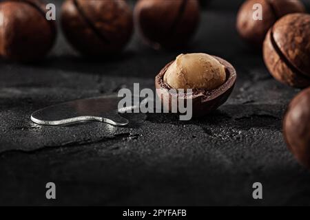 Opened Macadamia Nut And Opener Key For Open It Stock Photo