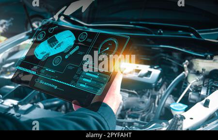 Auto mechanic checking engine system with OBD2 wireless scanning tool and car information showing on screen interface,Car maintenance service concept. Stock Photo