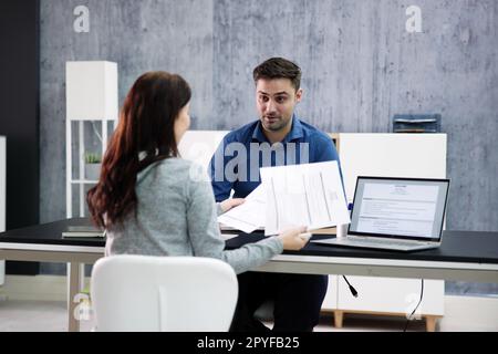 Two Businesspeople Talking With Each Other Stock Photo
