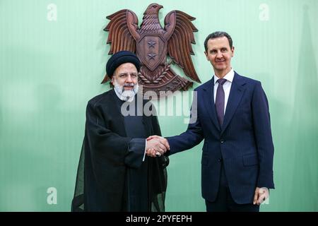 Damascus, Damascus, Syria. 3rd May, 2023. Syria's President BASHAR AL-ASSAD (R) shakes hands with his Iranian counterpart EBRAHIM RAISI in Damascus on May 3, 2023. Raisi congratulated al-Assad on May 3 for ''achieving victory'' in the country's 12-year-long civil war, in which Tehran has been a significant ally. (Credit Image: © Iranian Presidency via ZUMA Press Wire) EDITORIAL USAGE ONLY! Not for Commercial USAGE! Stock Photo