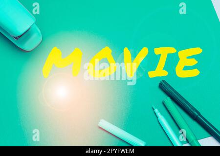 Hand writing sign Movie. Internet Concept Cinema or television film Motion picture Video displayed on screen Stock Photo
