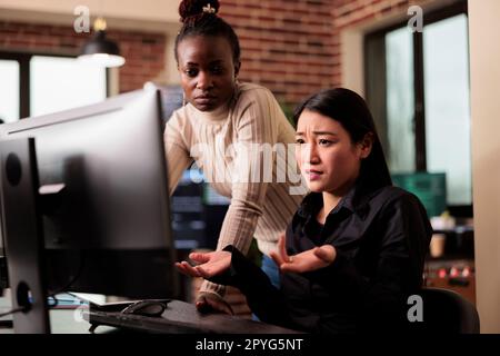 Software programers brainstorming ideas to write html code and create security program, displaying artificial intelligence algorithm. Pensive tech enginners thinking about database cloud computing Stock Photo