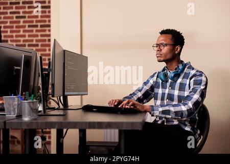 Tech enginner working on new user interface with online system to create algorithm in it agency office. Software developer programming html code algorithm on computer, typing sever data Stock Photo