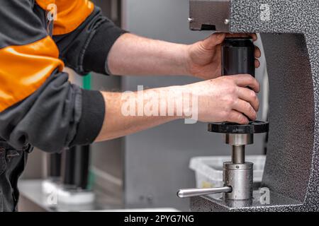 closed with the lid of beverage cans in an automatic capping machine in a brewery Stock Photo
