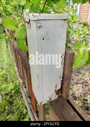 Old mailbox on a wooden fence close up Stock Photo